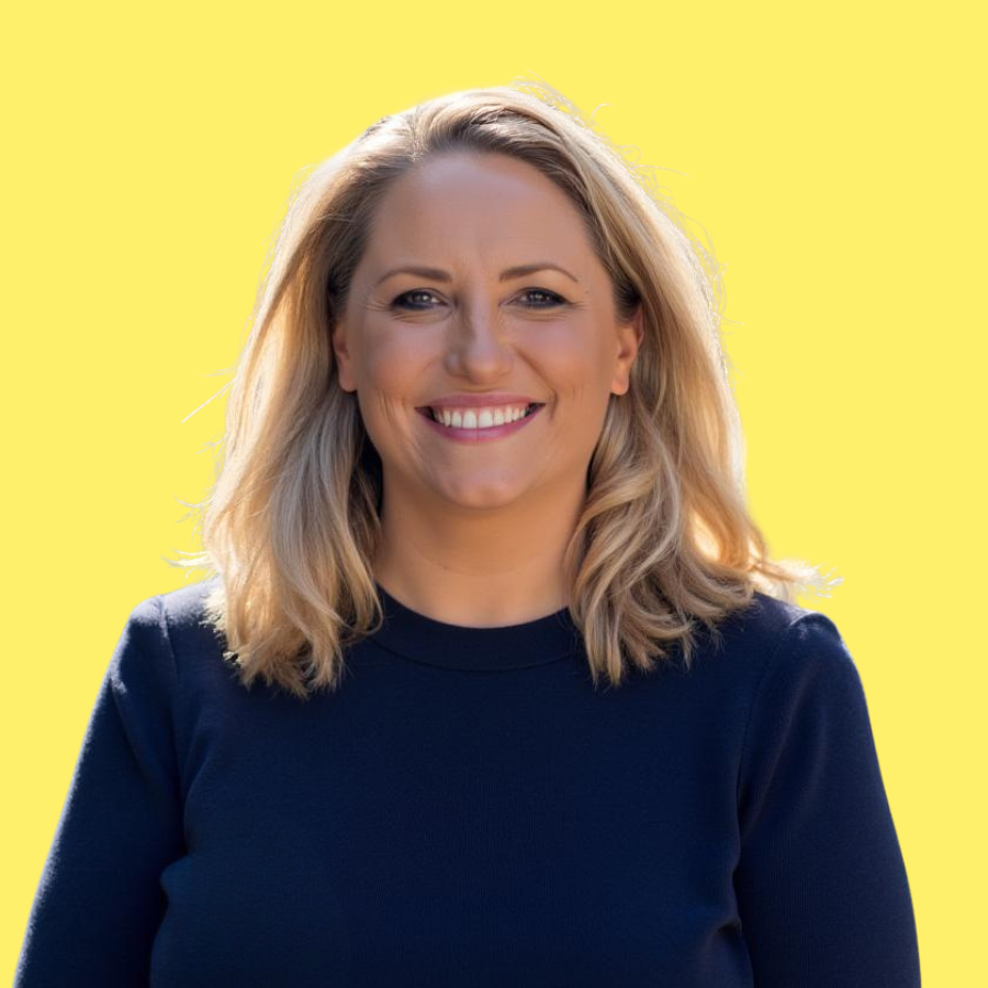 Rachel Wilkins, creator of 100 Days of Yay, smiling against a warm yellow background.